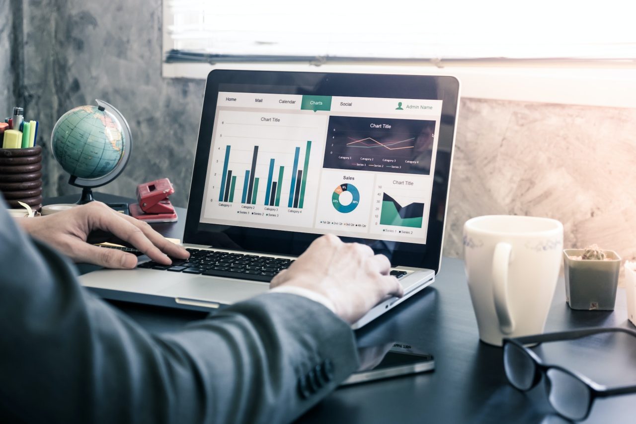 Businessman analyzing investment charts on the office desk.